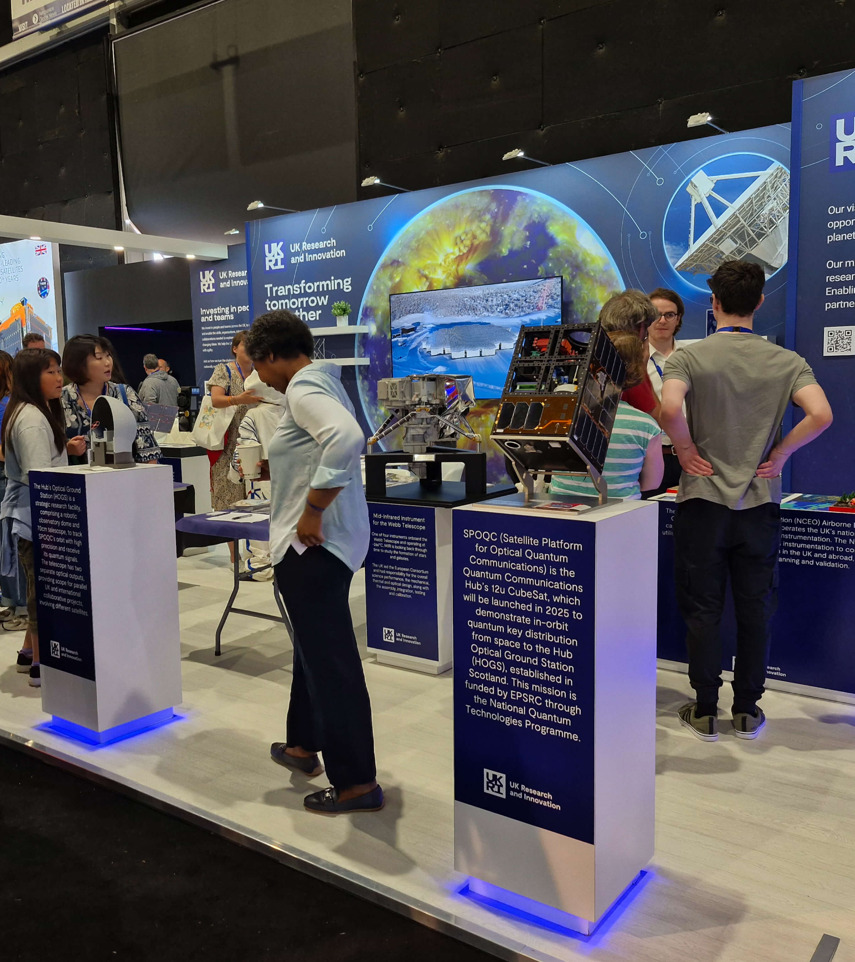 People looking at the exhibition stand